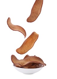 Image of Delicious crispy rusks falling into bowl on white background
