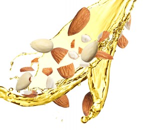 Organic almond oil and tasty nuts flying on white background