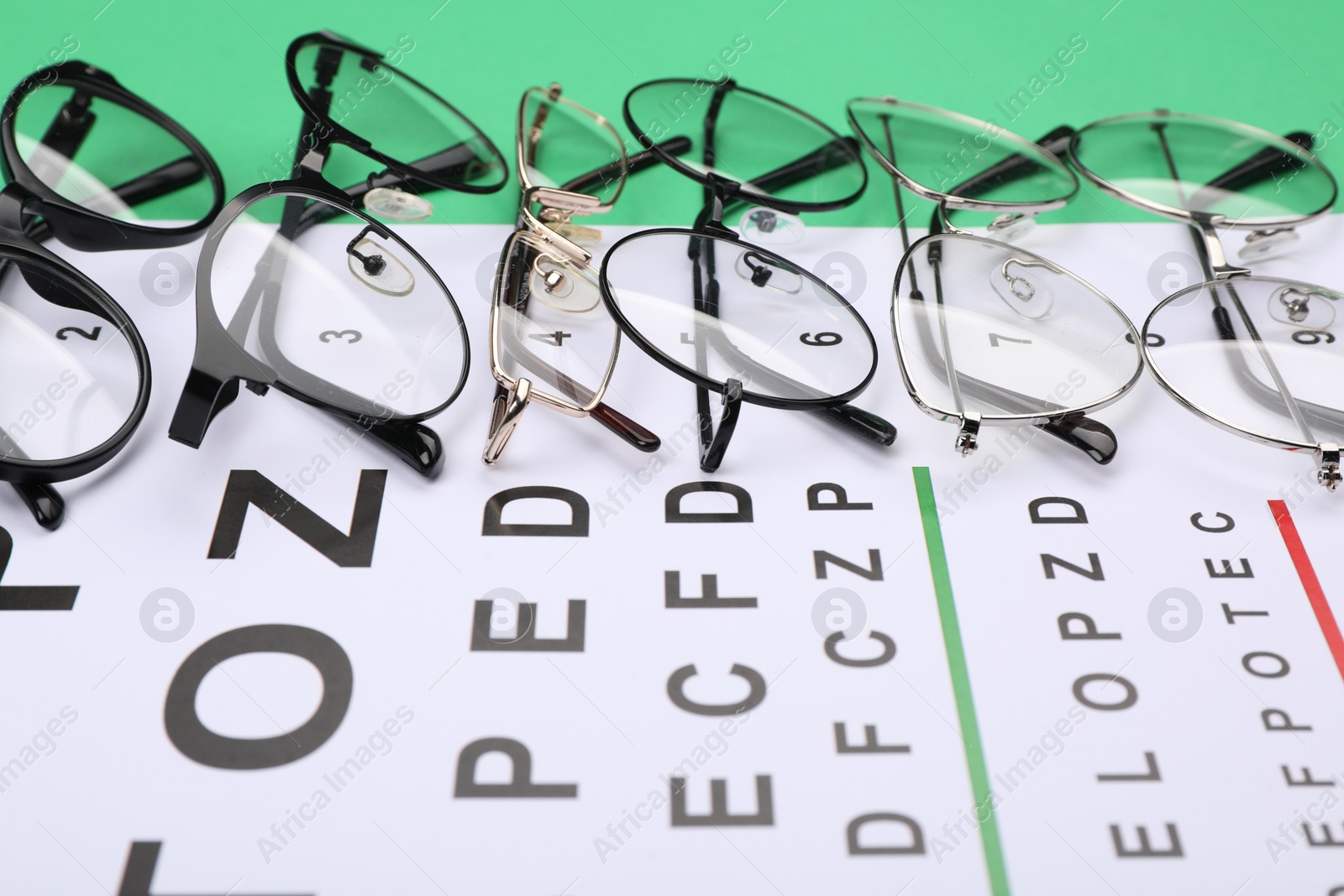 Photo of Vision test chart and glasses on table, closeup