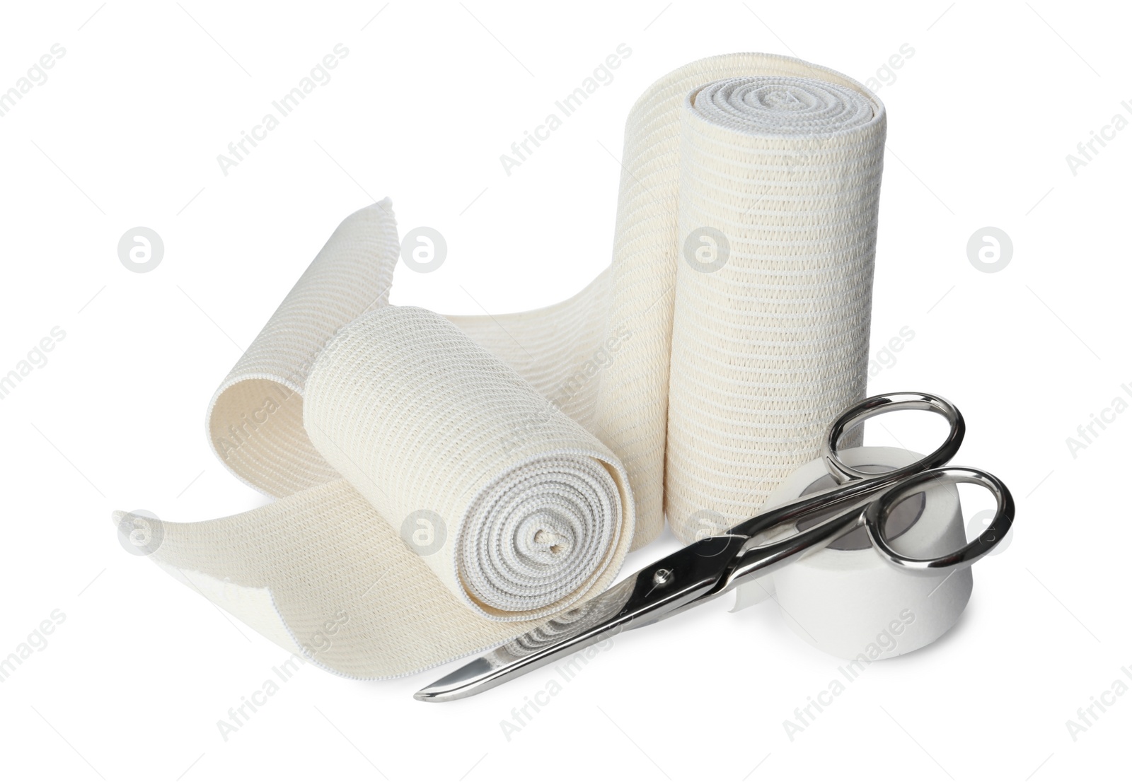 Photo of Medical bandage rolls, sticking plaster and scissors on white background