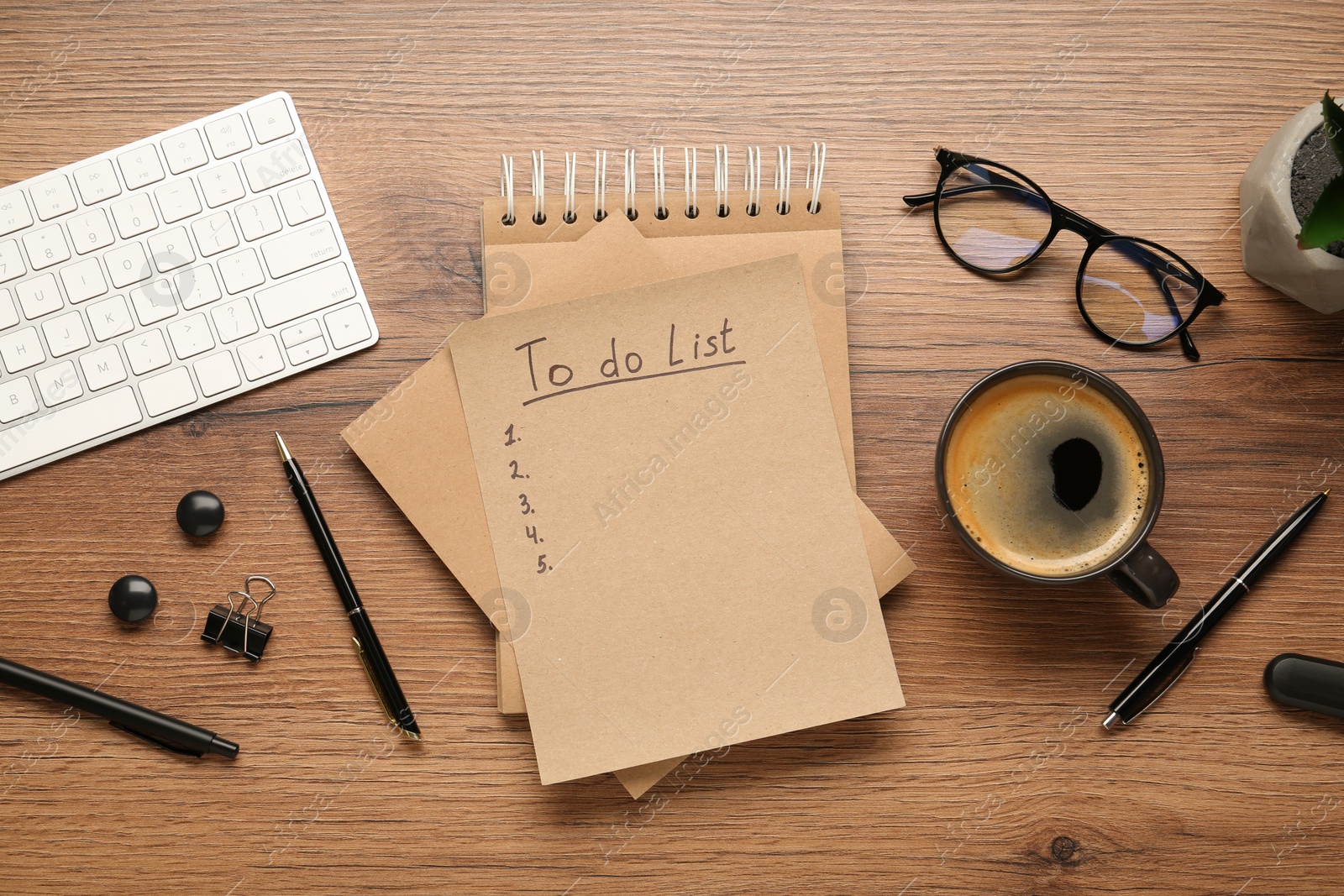 Photo of Flat lay composition with unfilled To Do list, cup of coffee and glasses on wooden table