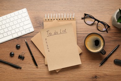 Photo of Flat lay composition with unfilled To Do list, cup of coffee and glasses on wooden table