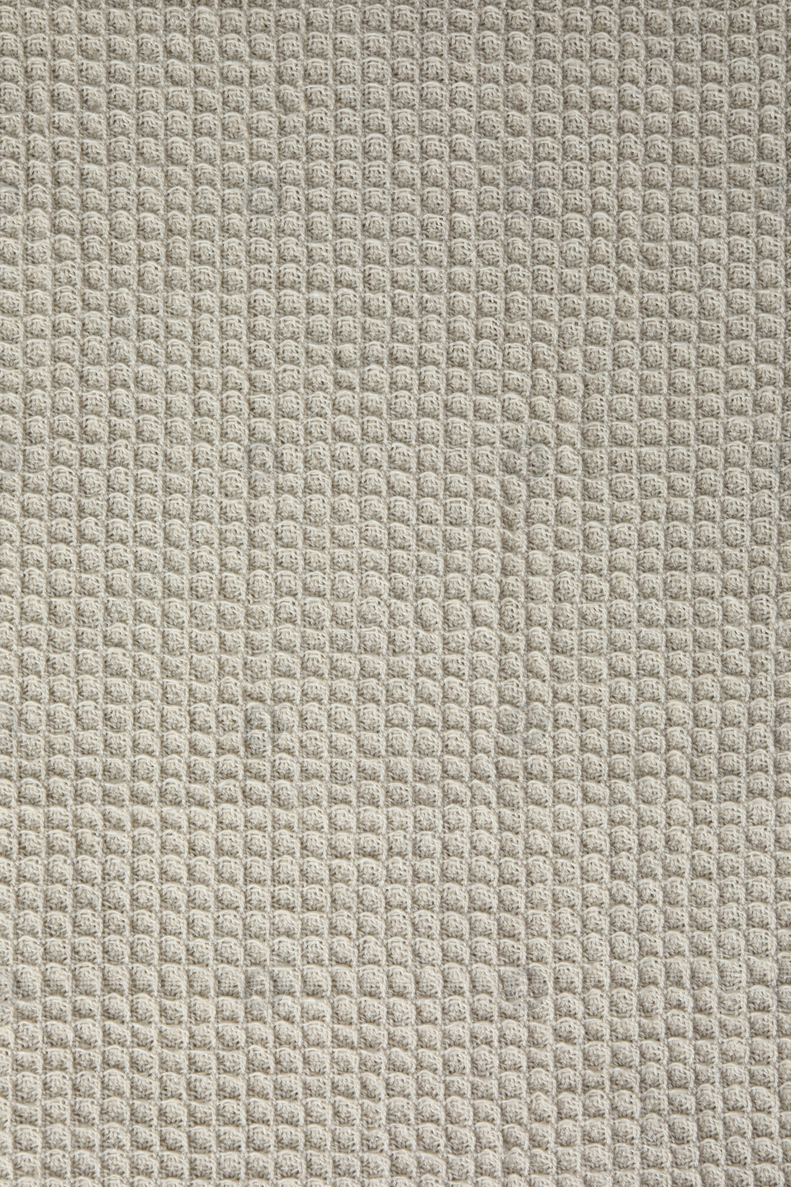 Photo of Texture of beige knitted fabric as background, top view