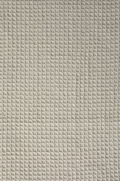 Photo of Texture of beige knitted fabric as background, top view