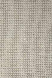 Texture of beige knitted fabric as background, top view