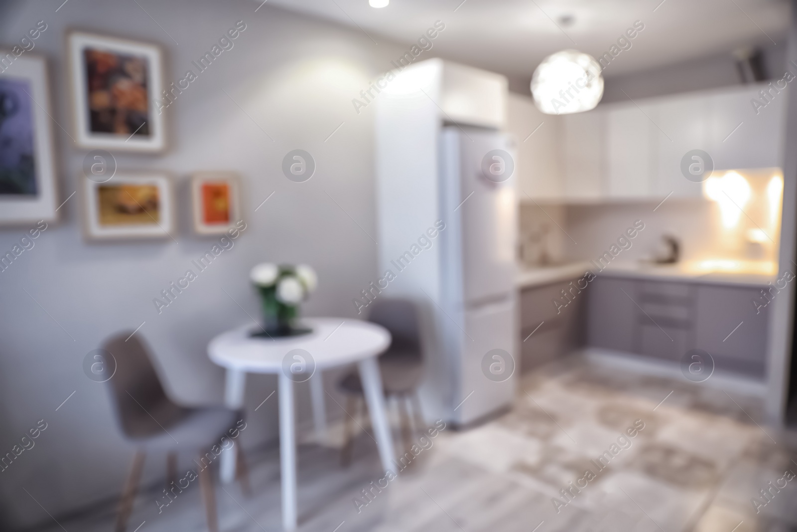 Photo of Blurred view of stylish modern kitchen interior