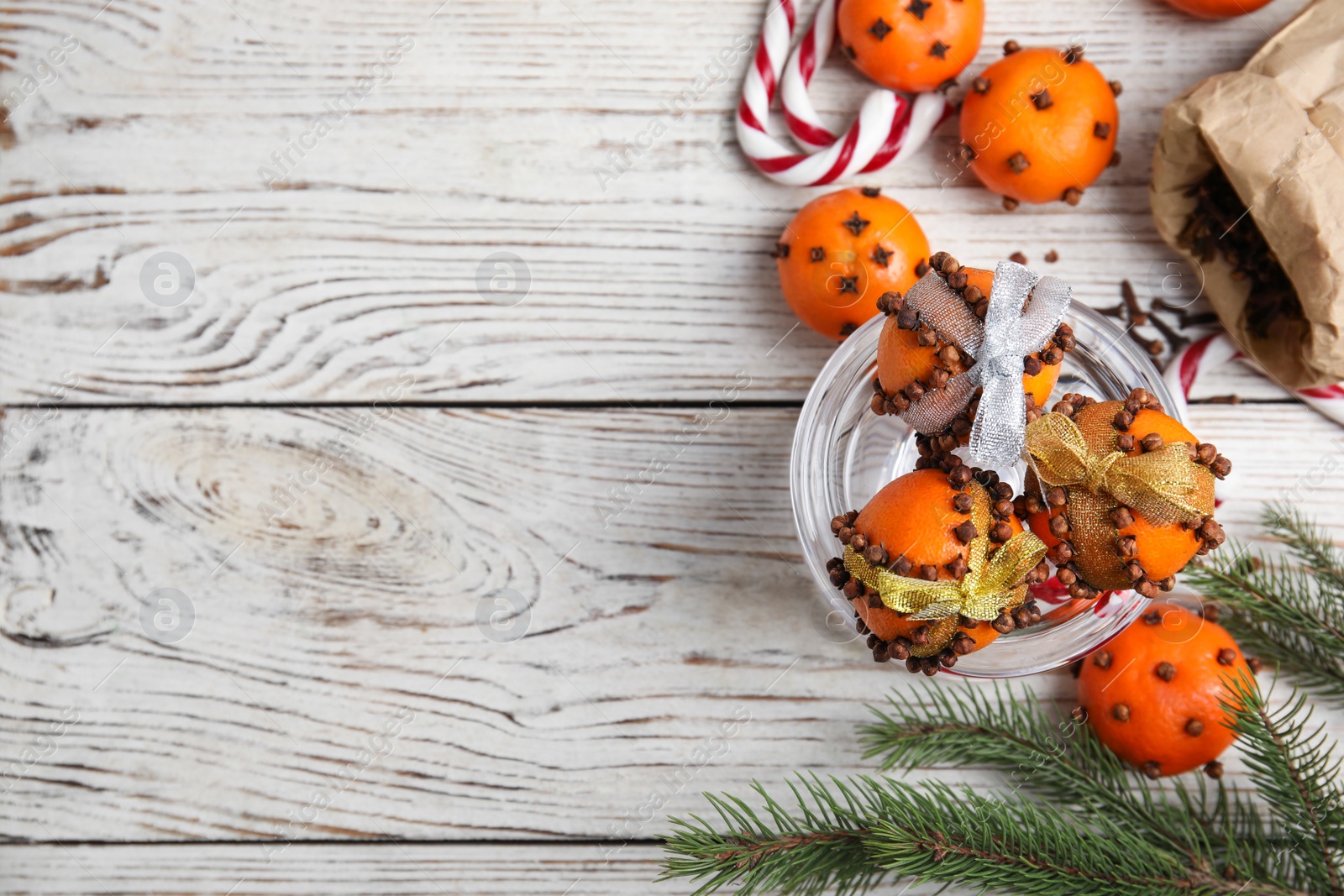 Photo of Flat lay composition with tangerine pomander balls on white wooden table, space for text