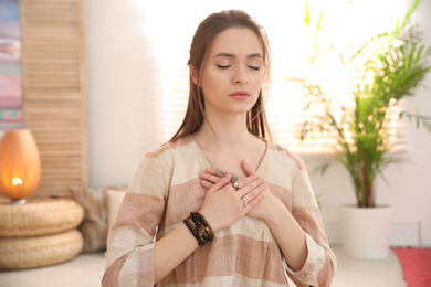 Photo of Young woman during self-healing session in therapy room