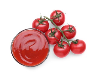 Photo of Bowl with tasty ketchup and fresh tomatoes isolated on white, top view