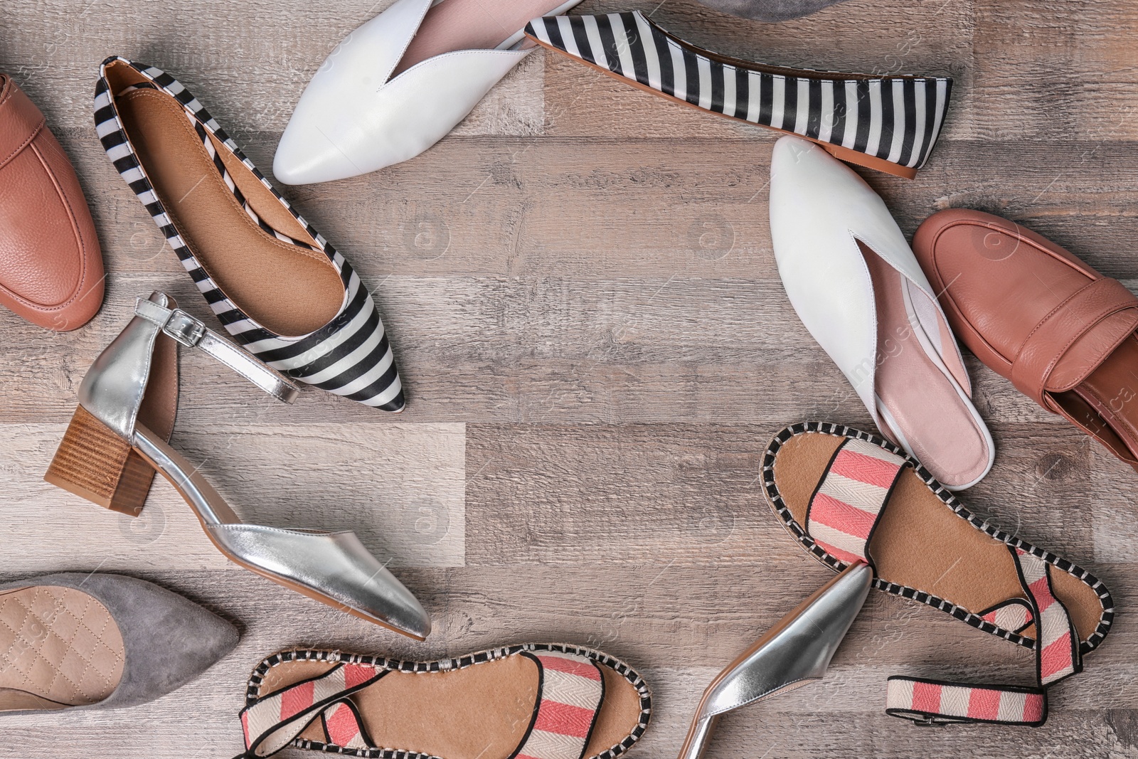 Photo of Different female shoes on wooden background, top view