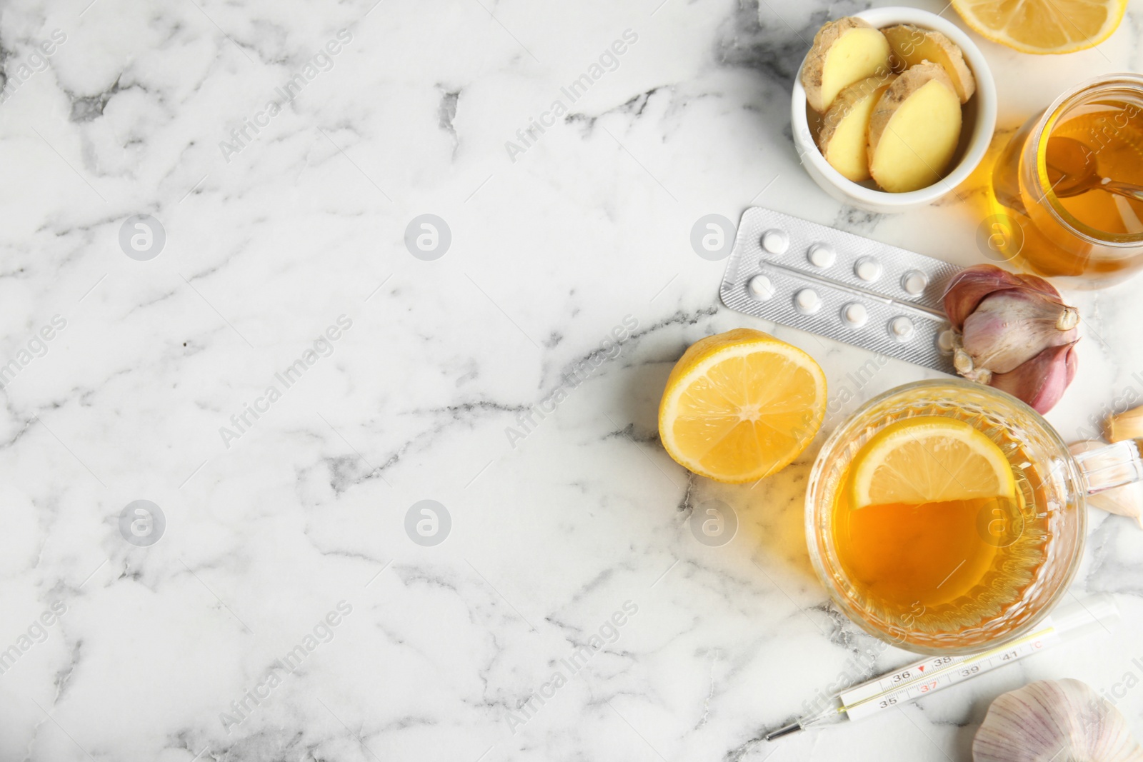 Photo of Flat lay composition with cold remedies on marble table, space for text. Sore throat treatment