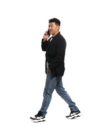 Man talking on smartphone while walking against white background