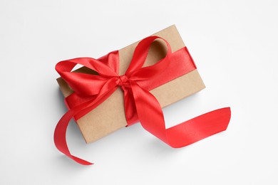 Photo of Beautiful gift box with red bow on white background, top view