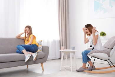 Photo of Mother scolding her teenager daughter at home