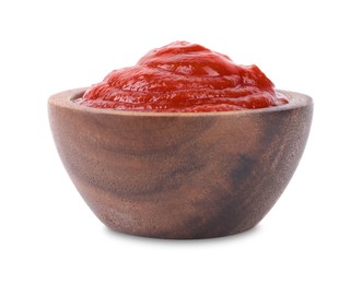 Photo of Organic ketchup in wooden bowl isolated on white. Tomato sauce