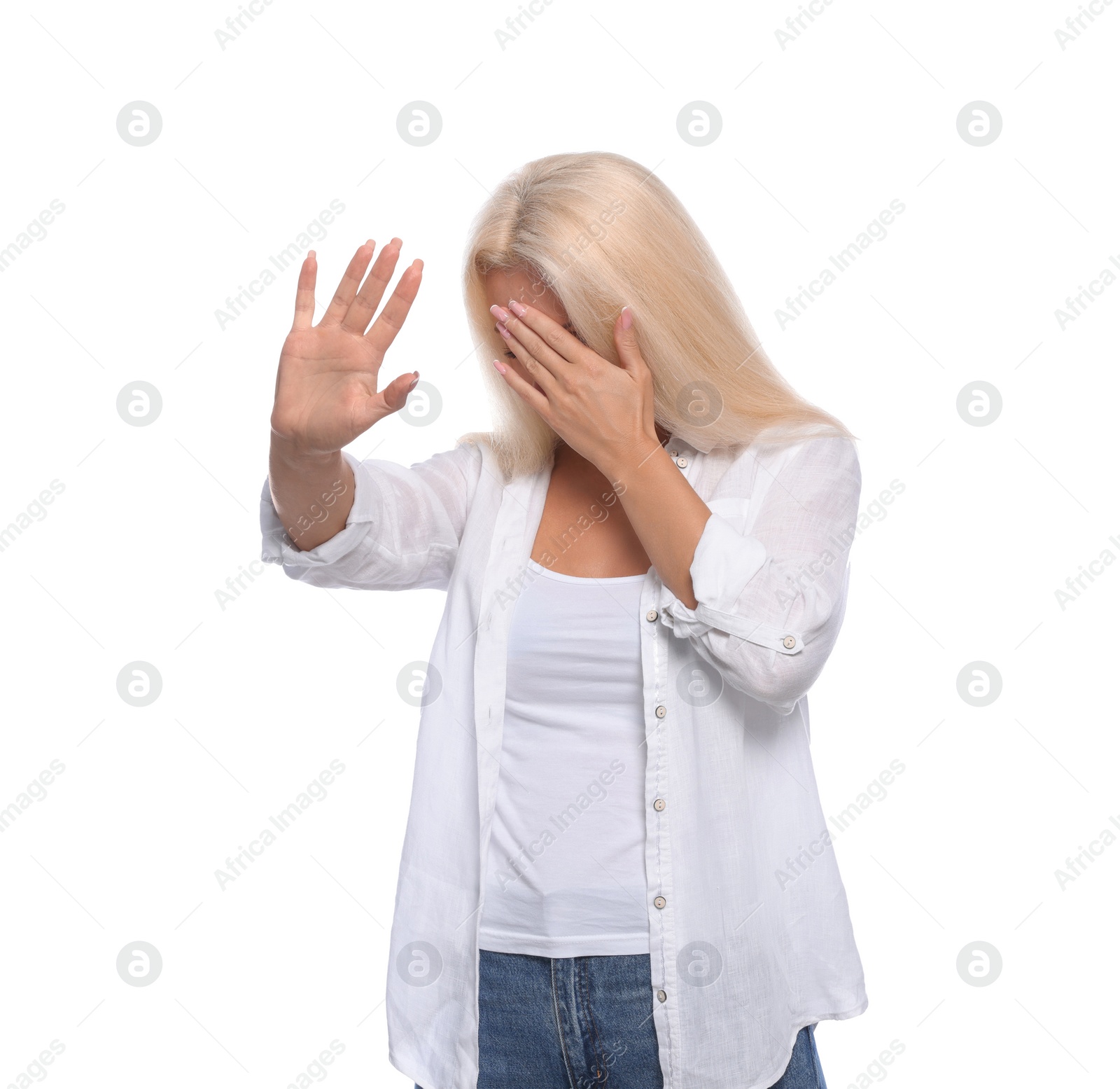 Photo of Embarrassed woman covering face with hand on white background
