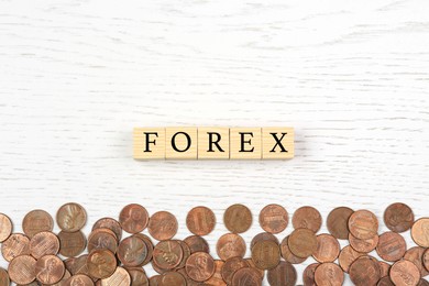 Photo of Word Forex with cubes and coins on white wooden table, flat lay
