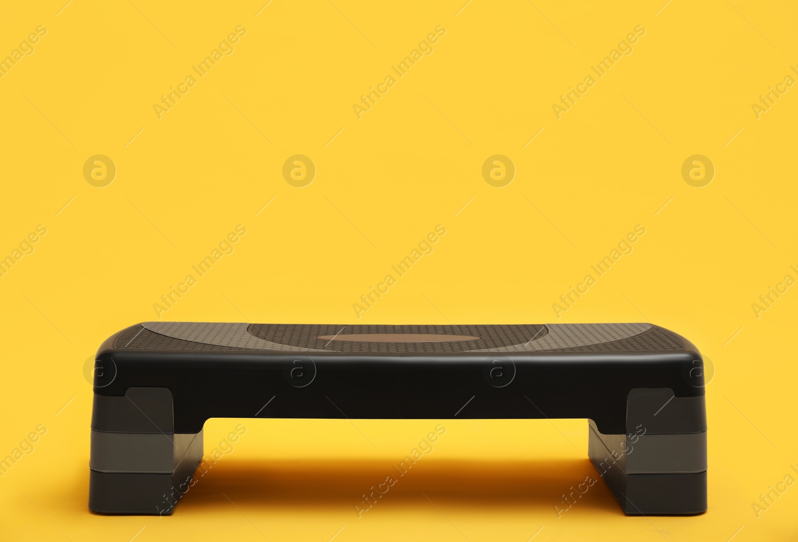 Photo of Step platform on yellow background. Sports equipment