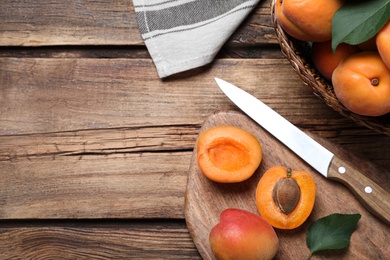 Delicious fresh ripe apricots on wooden table, flat lay. Space for text