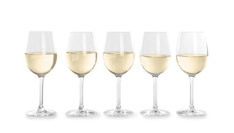 Glasses with white wine on light background