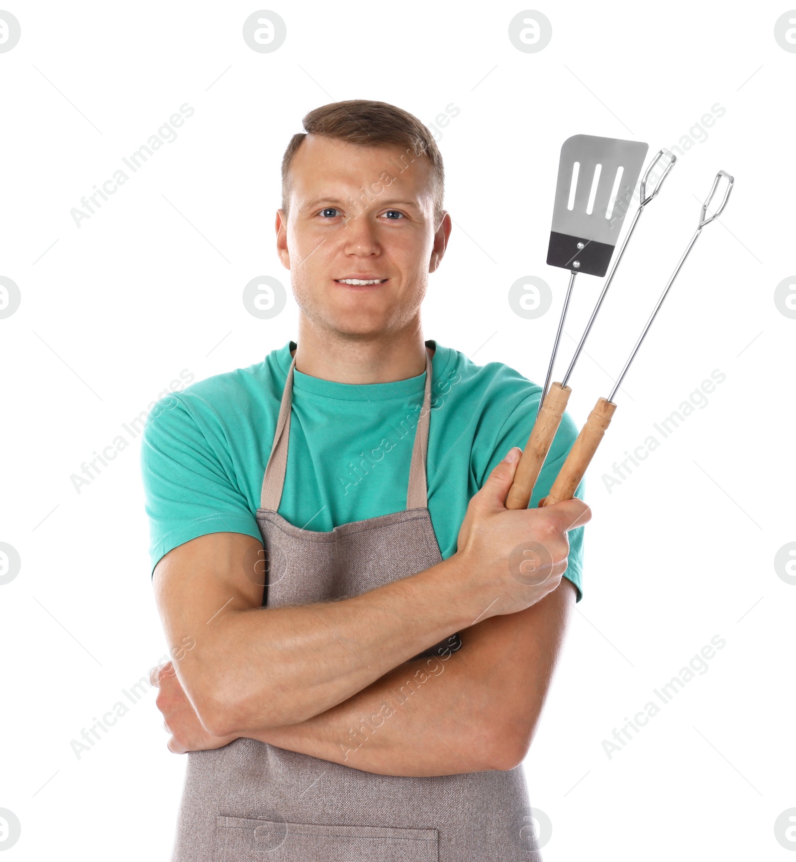 Photo of Man in apron with barbecue utensils on white background