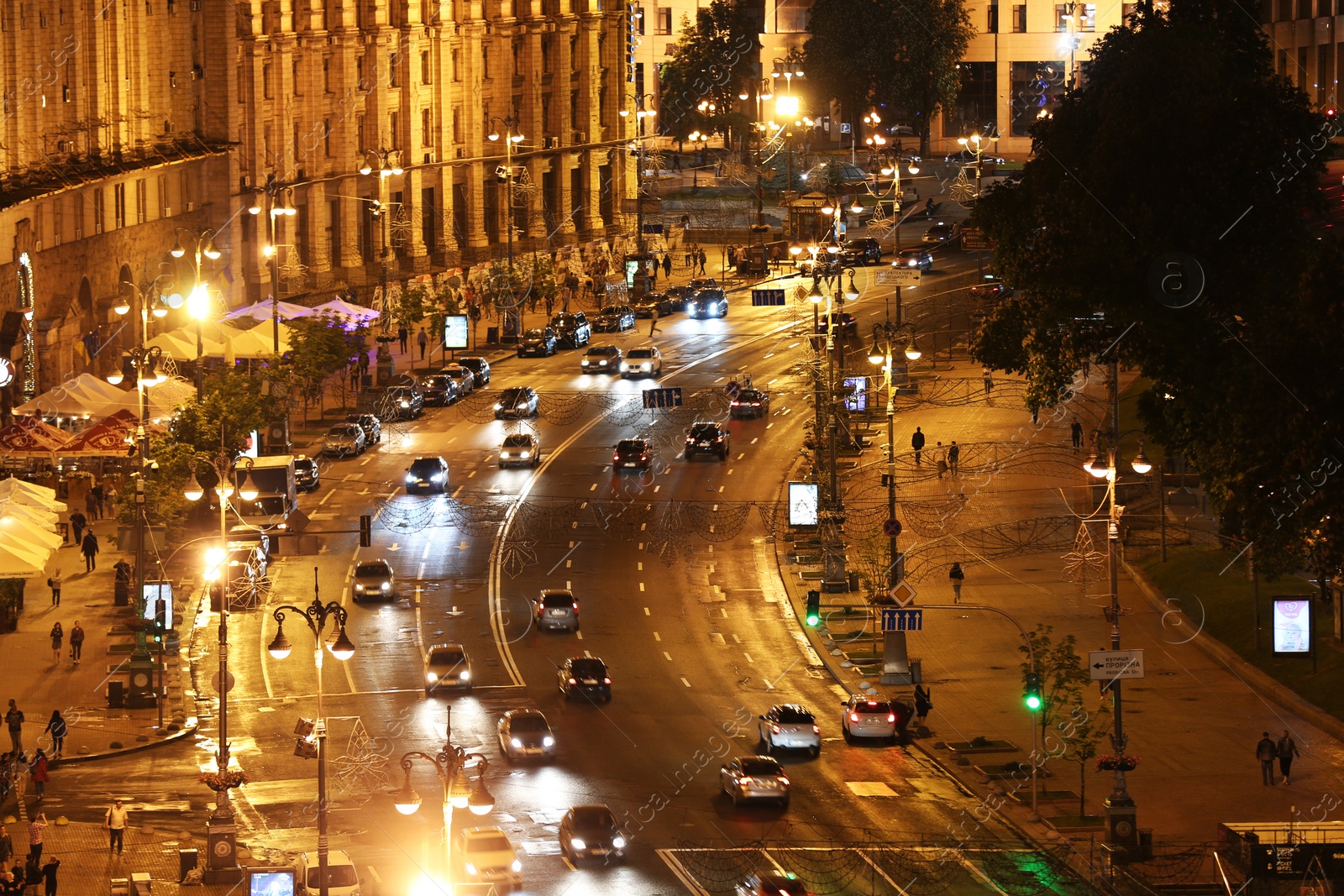 Photo of KYIV, UKRAINE - MAY 21, 2019: Night cityscape with illuminated buildings and street traffic