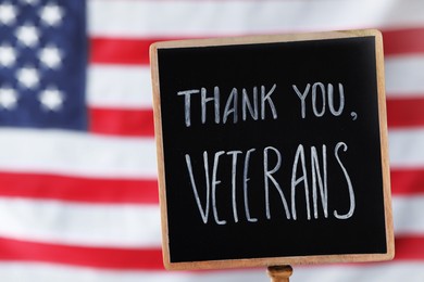 Photo of Sign with phrase Thank You, Veterans against American flag, closeup. Memorial Day