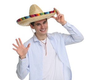 Young man in Mexican sombrero hat waving hello on white background