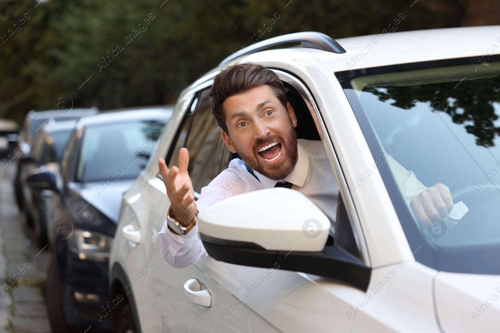 Photo of Angry driver screaming at someone from car in traffic jam