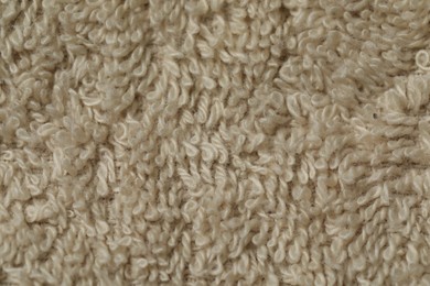 Photo of Texture of soft beige fabric as background, top view