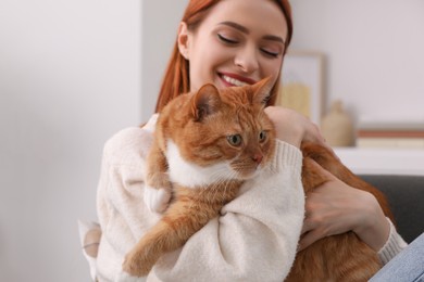 Happy woman with her cute cat at home