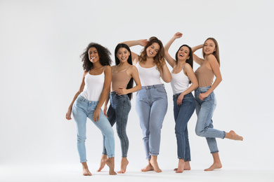 Group of women with different body types on light background