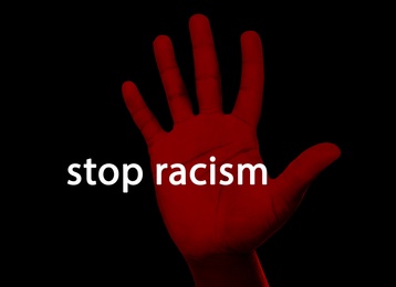Image of Stop Racism. Man showing hand on black background, closeup
