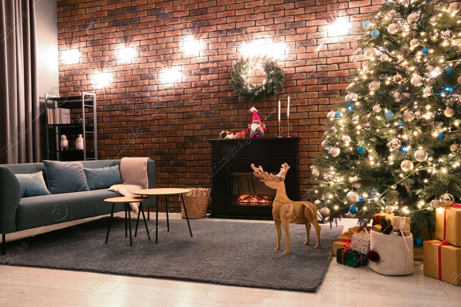 Photo of Beautiful tree with festive lights and Christmas decor in living room. Interior design