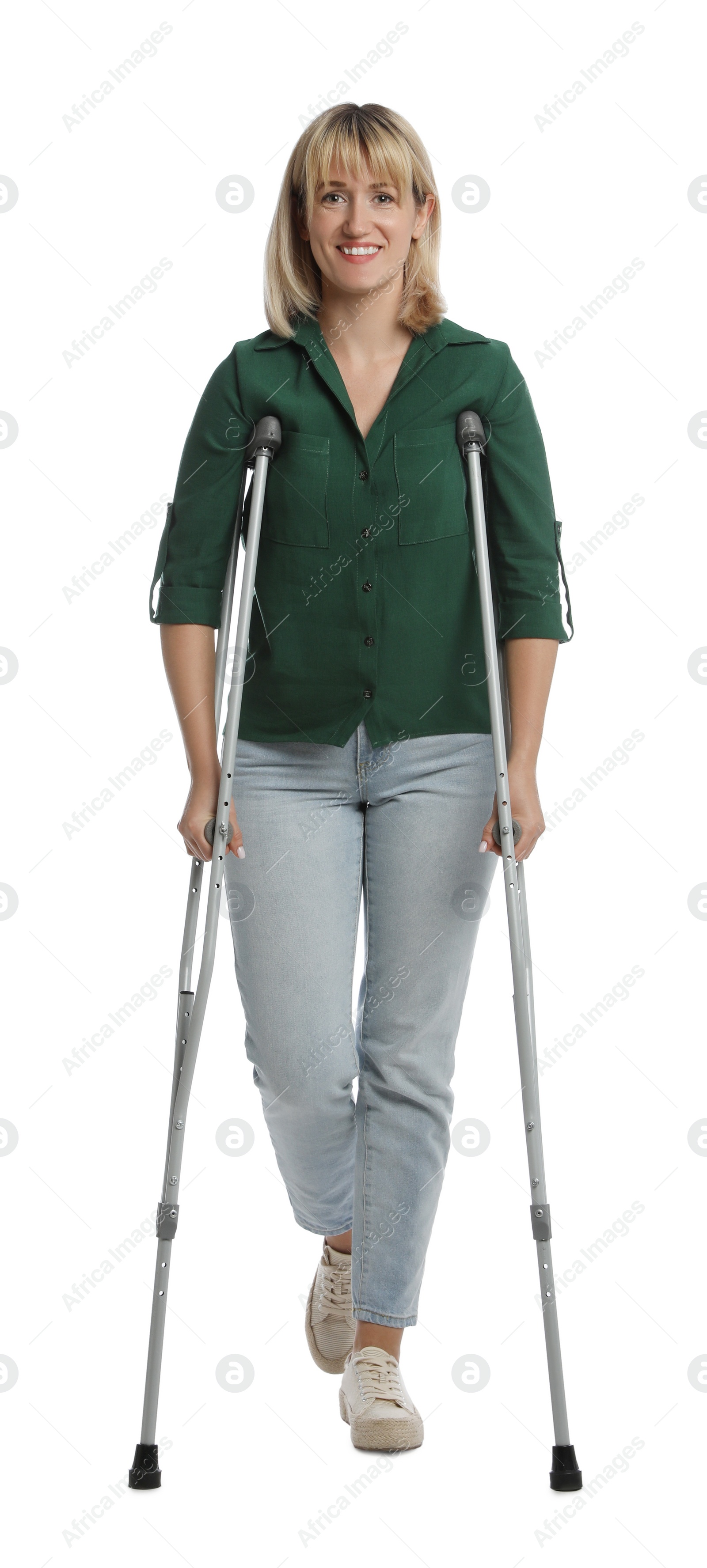 Photo of Full length portrait of woman with crutches on white background