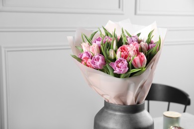 Photo of Vase with bouquet of beautiful tulips indoors, closeup. Space for text