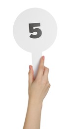 Photo of Woman holding auction paddle with number 5 on white background, closeup