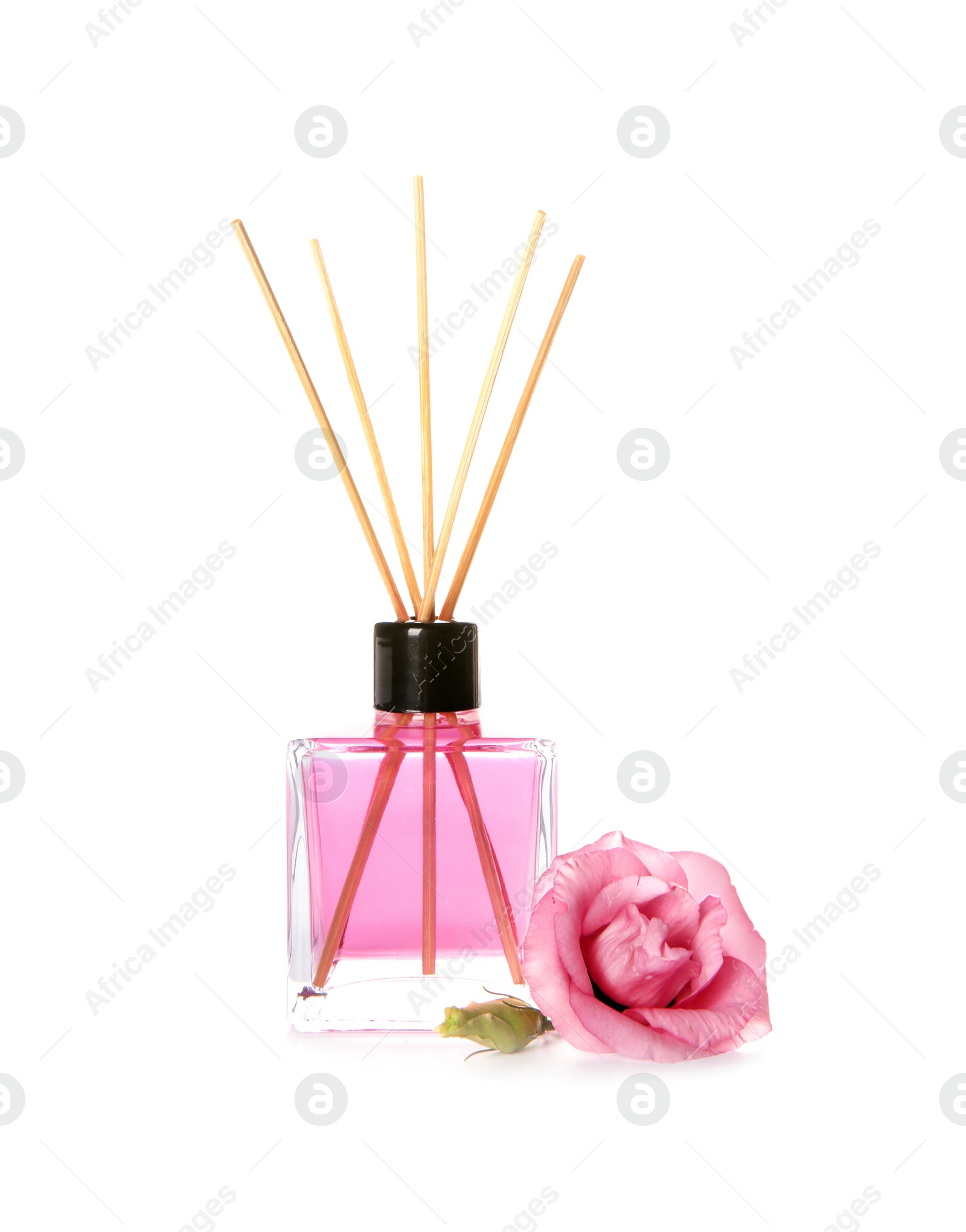 Photo of Aromatic reed air freshener and rose on white background