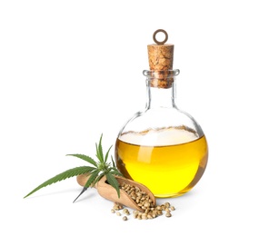 Bottle with hemp oil, leaf and seeds on white background