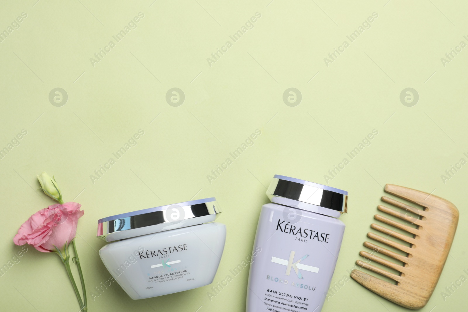 Photo of MYKOLAIV, UKRAINE - SEPTEMBER 07, 2021: Flat lay composition with Kerastase hair care cosmetic products on light green background. Space for text