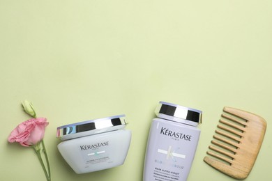 Photo of MYKOLAIV, UKRAINE - SEPTEMBER 07, 2021: Flat lay composition with Kerastase hair care cosmetic products on light green background. Space for text