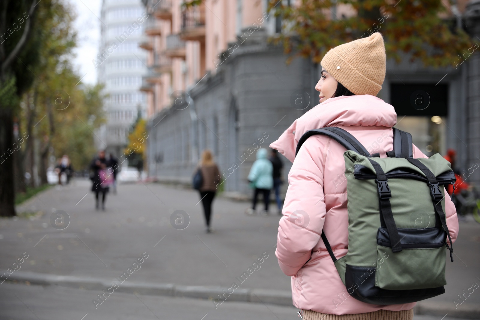 Photo of Young tourist with travel backpack in city on vacation. Space for text