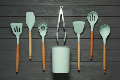 Set of different kitchen utensils on grey wooden table