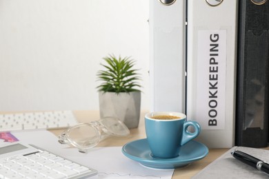 Bookkeeper's workplace with folders and documents on table