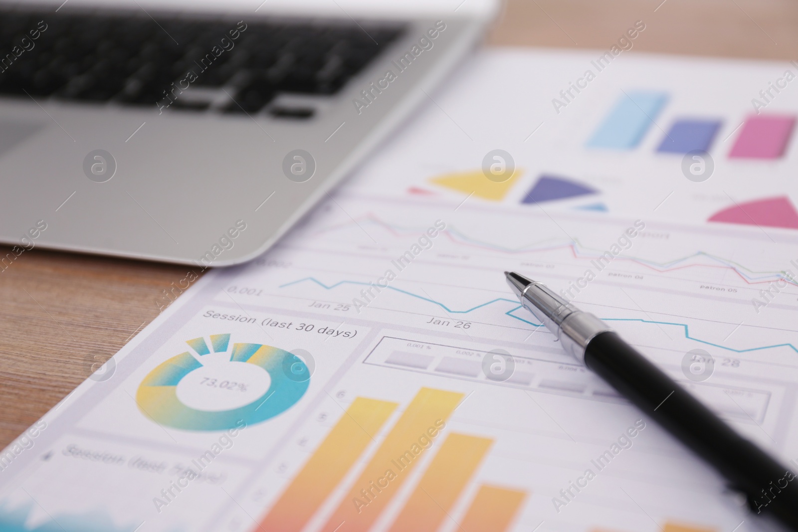 Photo of Paper document with charts and pen on table, closeup. Investment analysis