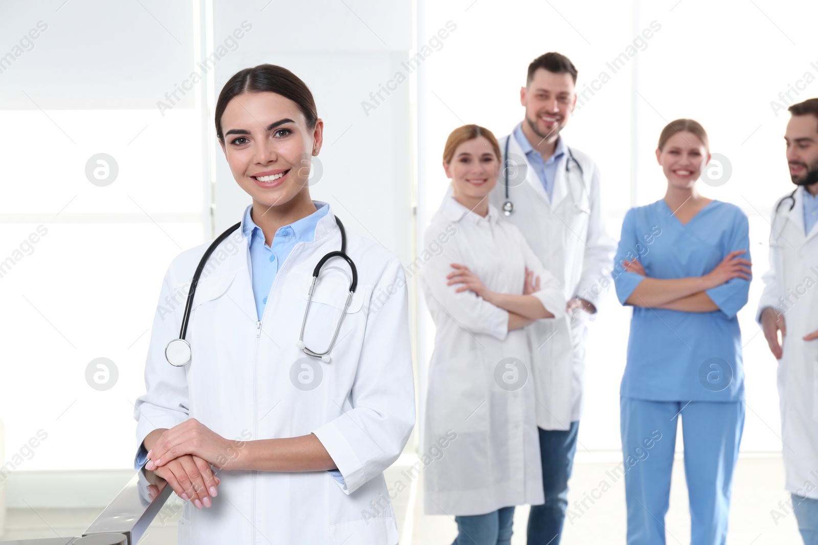 Photo of Young medical doctor with colleagues in clinic. Unity concept