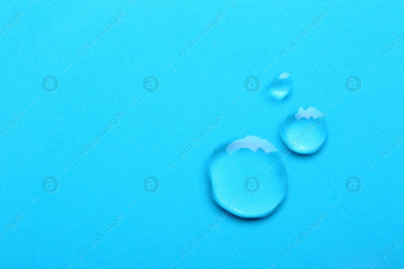 Photo of Water drops on color background, top view. Space for text