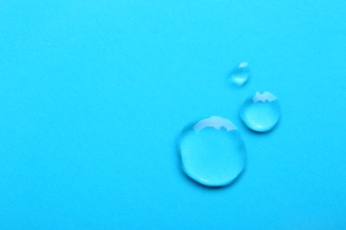 Photo of Water drops on color background, top view. Space for text