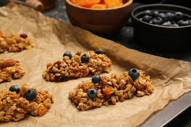 Photo of Different granola bars and ingredients on table. Healthy snack