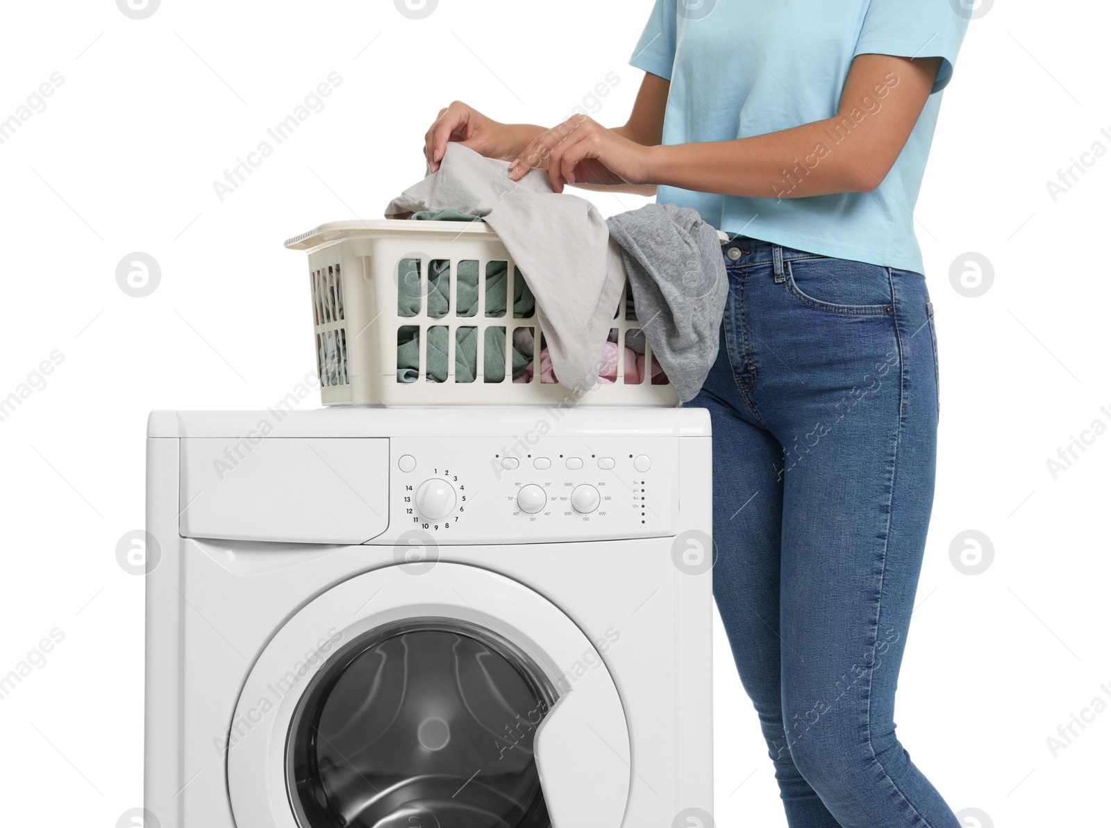 Photo of Woman taking laundry out of basket and washing machine on white background, closeup